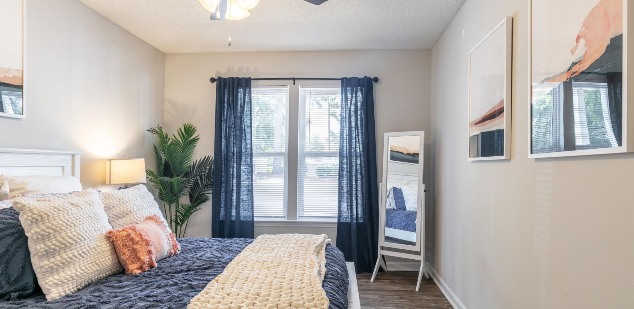 Hawthorne Commons spacious apartment bedroom with wood vinyl flooring and large windows